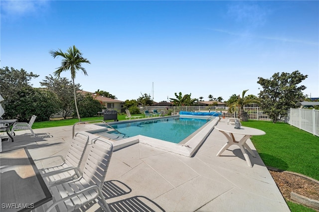 view of pool featuring a patio, a lawn, a fenced in pool, and a fenced backyard