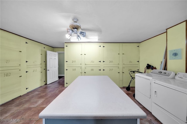 washroom featuring washer and clothes dryer and cabinet space