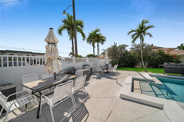 view of patio / terrace featuring area for grilling, outdoor dining area, and a fenced backyard