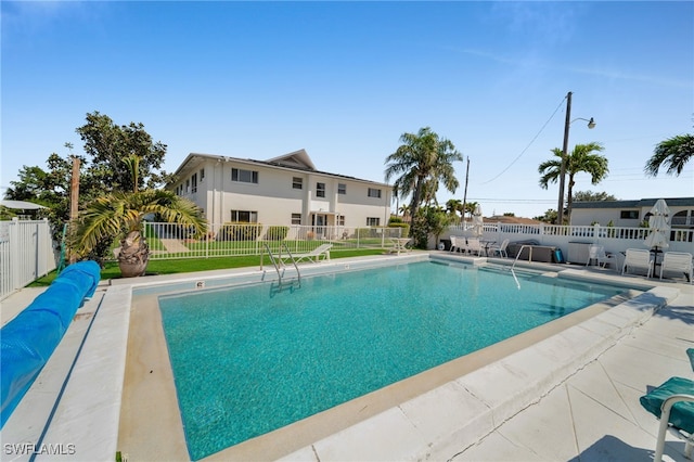 view of swimming pool with a patio area, a yard, a fenced backyard, and a fenced in pool