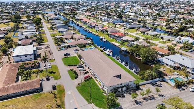 drone / aerial view featuring a residential view and a water view