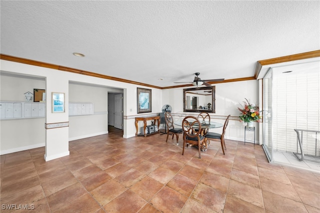 dining area with a textured ceiling, crown molding, baseboards, and ceiling fan