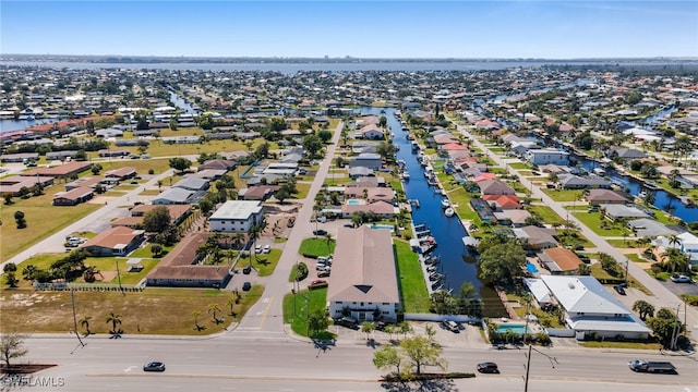 drone / aerial view with a residential view and a water view