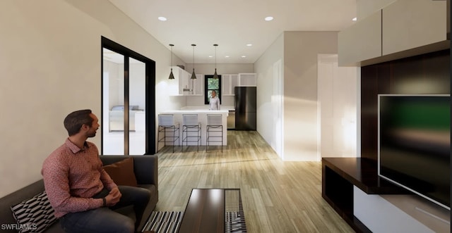 living area with recessed lighting, separate washer and dryer, and light wood-style floors