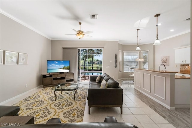 9011 Springview Loop, Estero, FL 33928 - living room with crown molding, light tile patterned floors, baseboards, and a ceiling fan