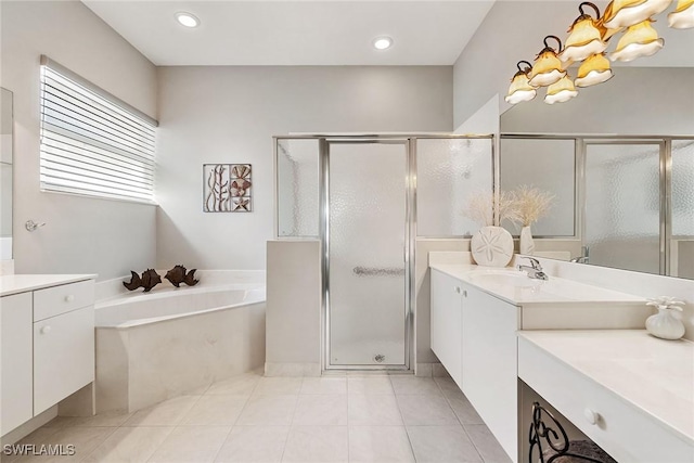 9011 Springview Loop, Estero, FL 33928 - full bath featuring two vanities, a shower stall, a bath, tile patterned flooring, and recessed lighting
