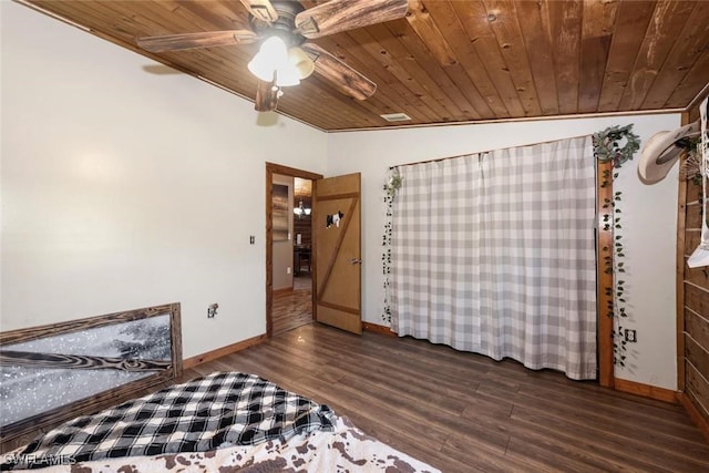 unfurnished bedroom with dark wood-type flooring, a ceiling fan, wooden ceiling, baseboards, and vaulted ceiling