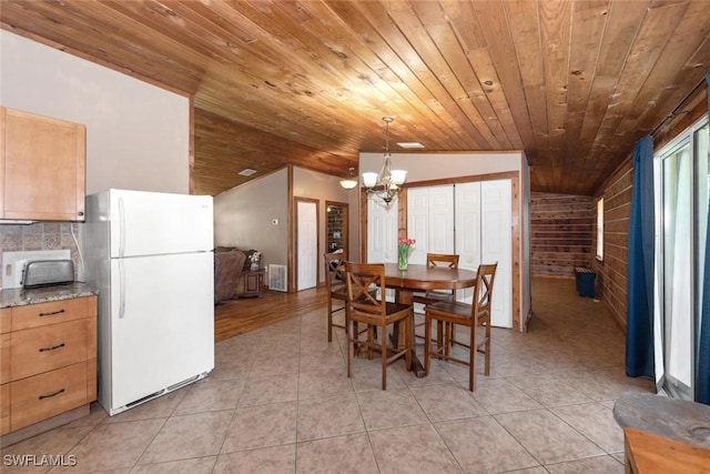 dining area featuring light tile patterned floors, an inviting chandelier, wooden ceiling, and lofted ceiling