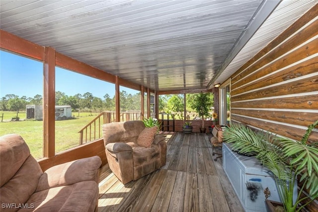 wooden terrace with an outdoor structure and a yard