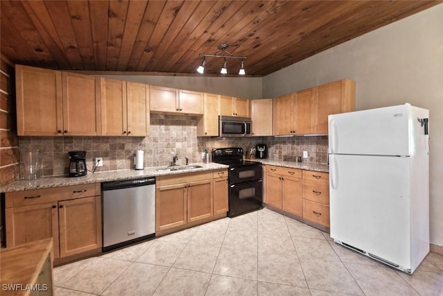 kitchen with light stone counters, light tile patterned flooring, a sink, decorative backsplash, and appliances with stainless steel finishes