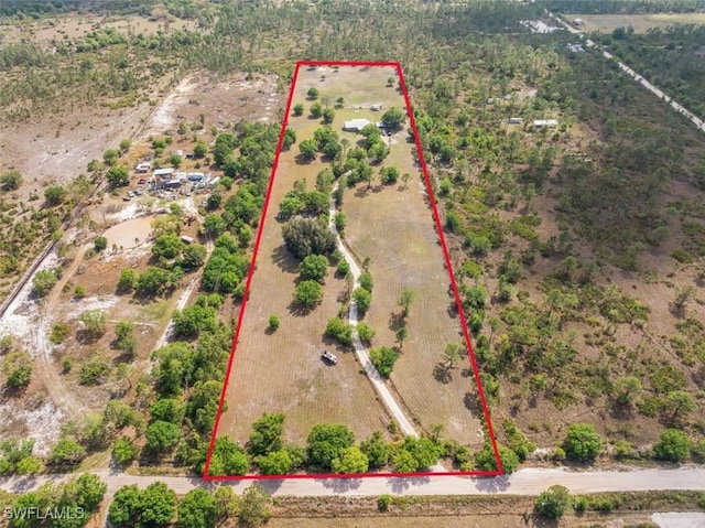 birds eye view of property with a rural view