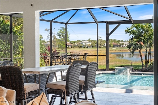 outdoor pool with a water view, a patio, a lanai, and outdoor dining space