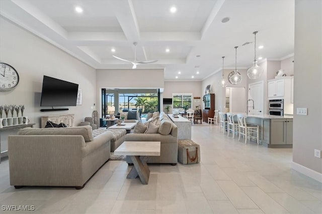 living area featuring recessed lighting, coffered ceiling, and a high ceiling