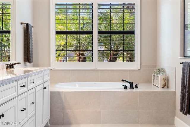 full bath featuring vanity and a garden tub