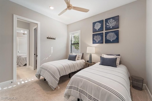 carpeted bedroom with ceiling fan and baseboards