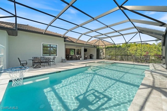 pool featuring glass enclosure, a patio, outdoor dining area, and an in ground hot tub