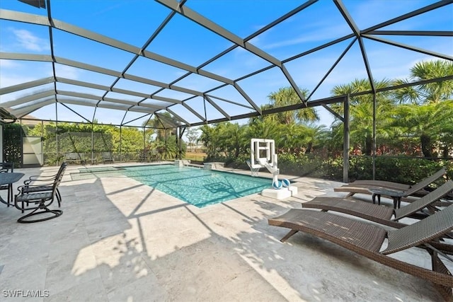 outdoor pool with a patio area and a lanai