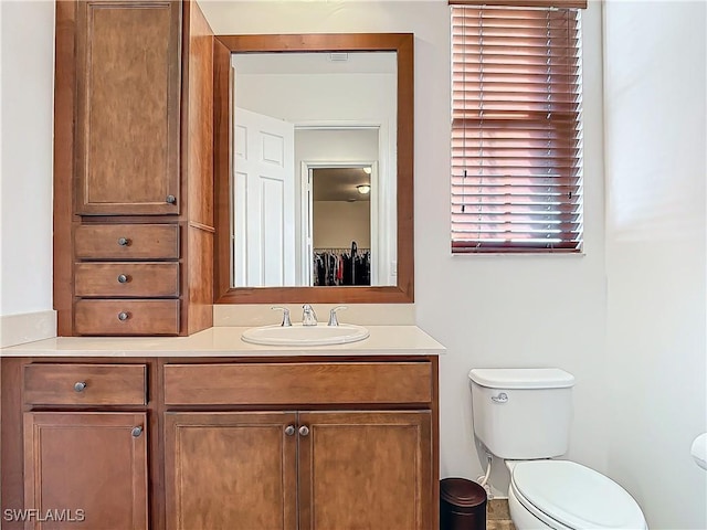 bathroom featuring toilet and vanity