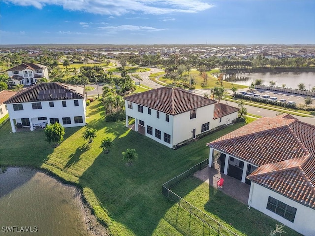 drone / aerial view with a residential view and a water view