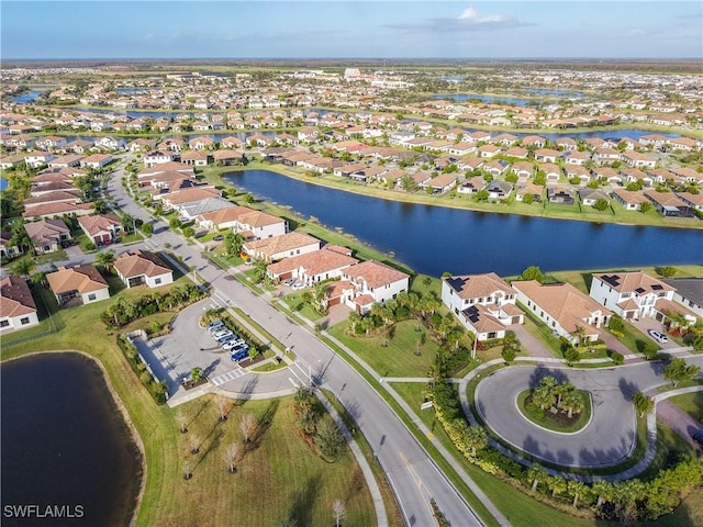 drone / aerial view featuring a residential view and a water view