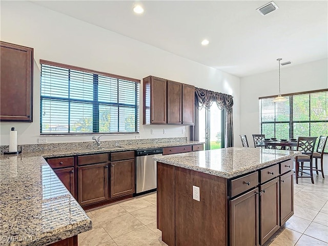 kitchen with dark brown cabinets, pendant lighting, light stone counters, recessed lighting, and stainless steel dishwasher