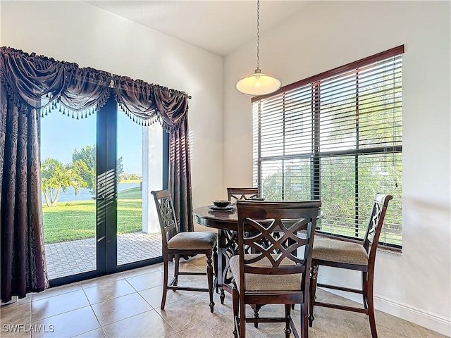 dining space with light tile patterned floors, french doors, and baseboards