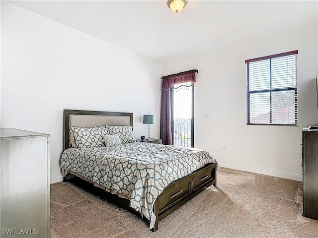 bedroom featuring carpet flooring, baseboards, and access to outside