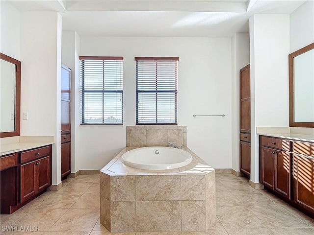 bathroom featuring tile patterned floors, vanity, and a garden tub