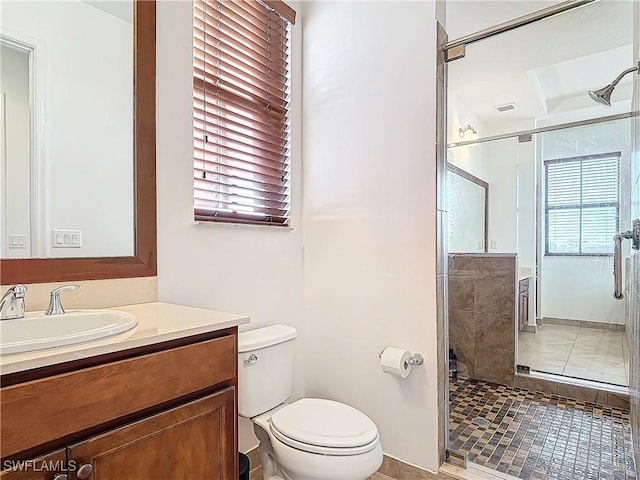 full bathroom with vanity, toilet, visible vents, and a stall shower