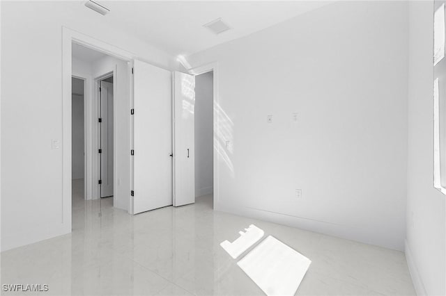 spare room featuring visible vents and marble finish floor