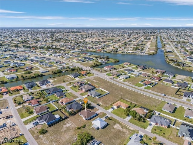 birds eye view of property featuring a water view and a residential view