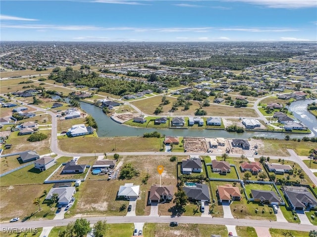 drone / aerial view with a residential view and a water view