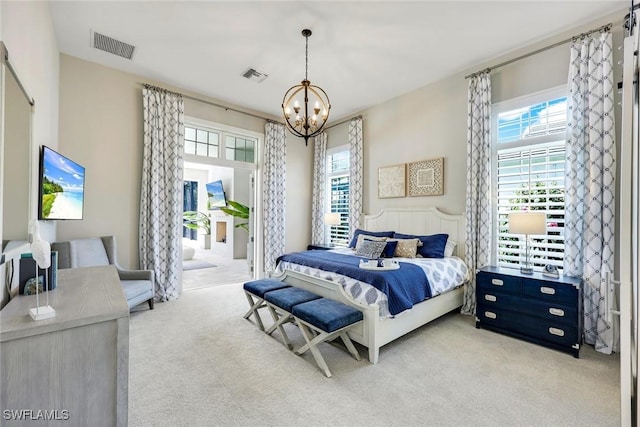 bedroom featuring a notable chandelier, visible vents, and carpet