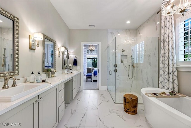 full bath with a chandelier, a marble finish shower, marble finish floor, and a sink