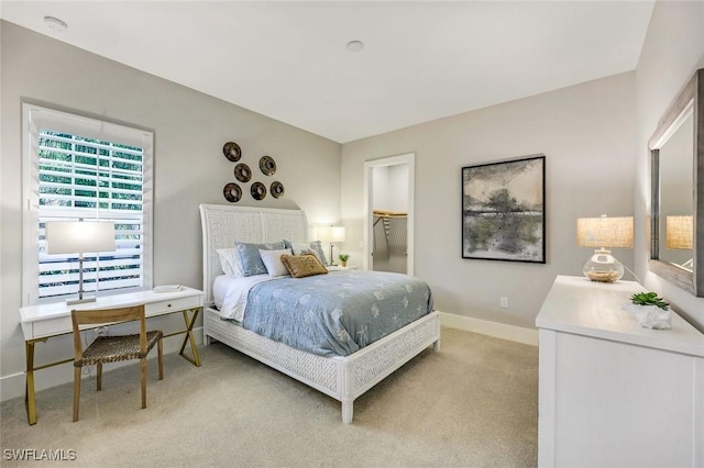 bedroom with baseboards and light carpet