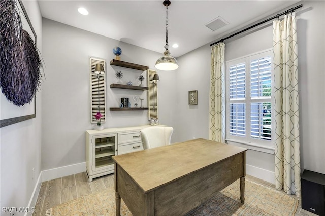 office space featuring recessed lighting, visible vents, light wood-style flooring, and baseboards