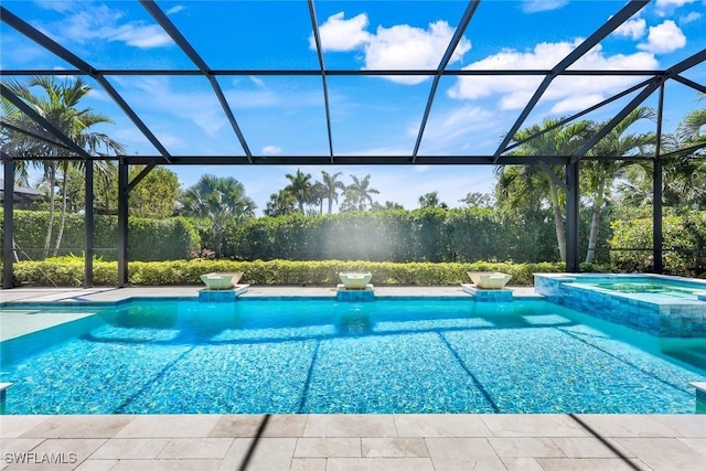 view of pool featuring a lanai and a pool with connected hot tub