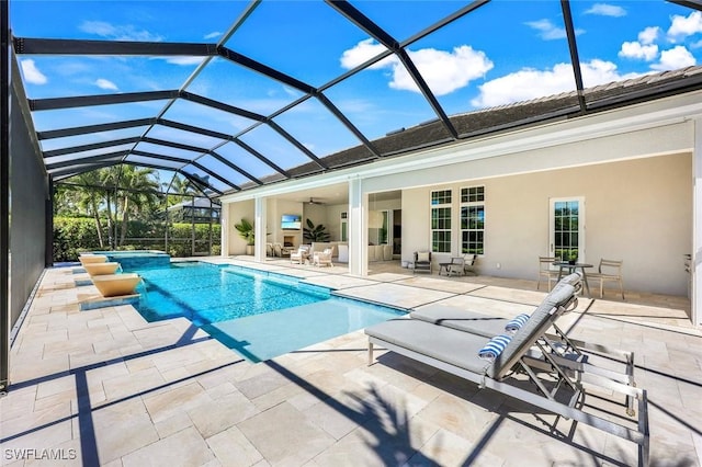 view of pool featuring a patio, a ceiling fan, and a pool with connected hot tub