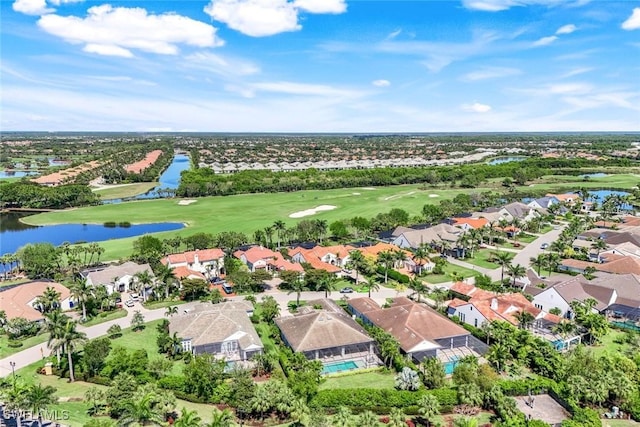 drone / aerial view with golf course view, a water view, and a residential view