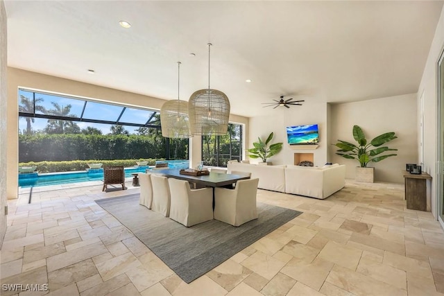 view of patio featuring an outdoor pool, a lanai, and ceiling fan