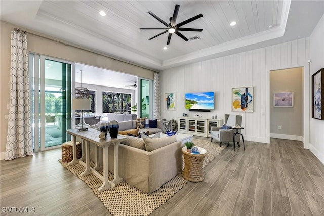 living area featuring ceiling fan, wooden ceiling, a tray ceiling, and wood finished floors