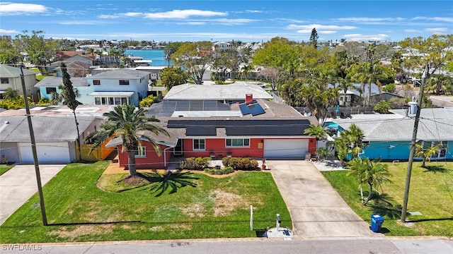 birds eye view of property with a residential view and a water view
