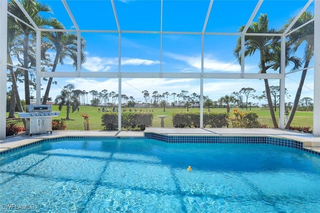 pool with glass enclosure, a grill, a lawn, and a patio