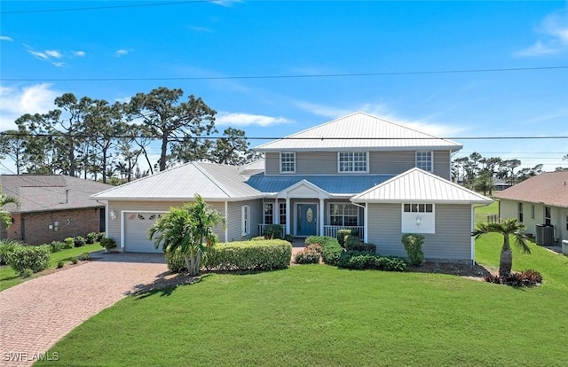 864 SW 18th Ter, Cape Coral, FL 33991 - view of front of house featuring decorative driveway, central AC unit, a garage, and a front yard
