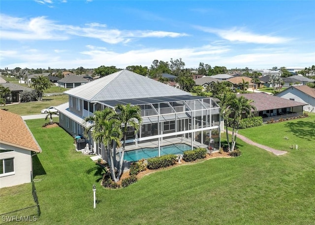 outdoor pool with glass enclosure, a residential view, and a yard