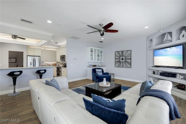 living area featuring wood finished floors, recessed lighting, a ceiling fan, and visible vents