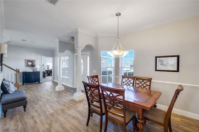 dining space with visible vents, baseboards, ornate columns, ornamental molding, and light wood-style floors