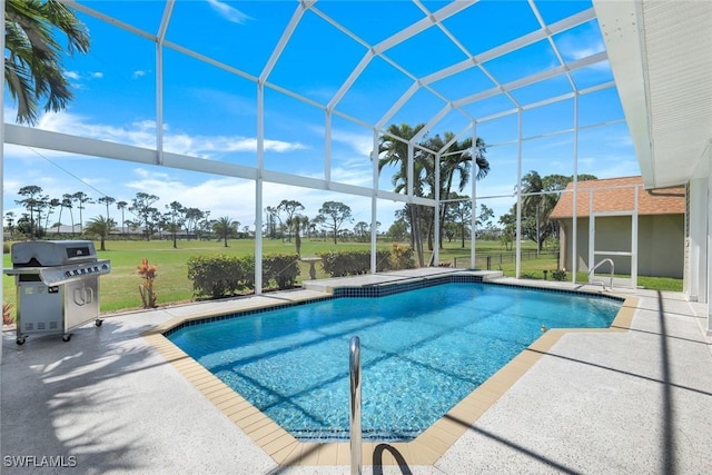 pool featuring a patio area, area for grilling, a lawn, and glass enclosure