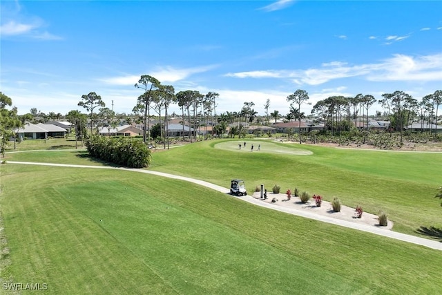 view of home's community with a lawn and view of golf course