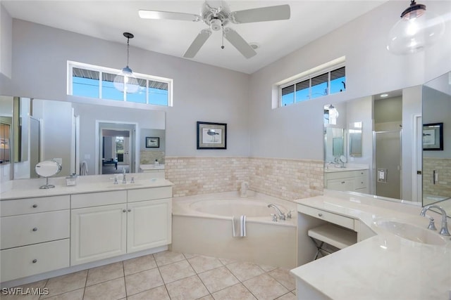 full bath with tile patterned flooring, a shower stall, a garden tub, and a sink